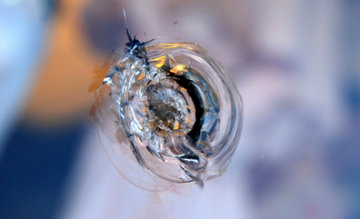 Bullet hole in glass as How to develop a bulletproof SEO content marketing strategy featured image