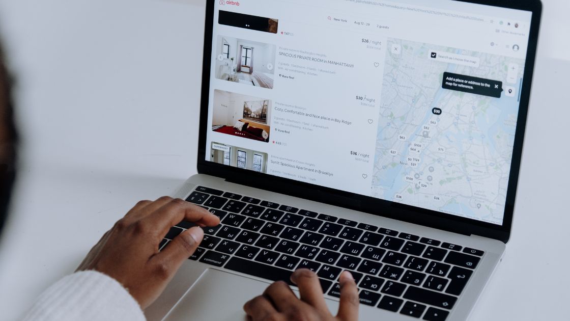 Professional sitting at a desk looking at a map on a laptop